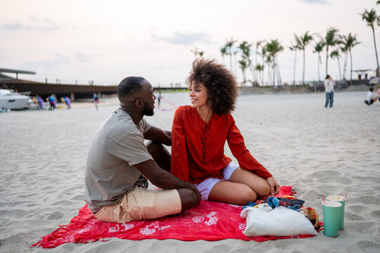 Happy diverse couple enjoying a romantic summer vacation and celebrating their love together
