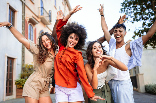 Diverse group of friends celebrates joy and togetherness while traveling, expressing pure happiness
