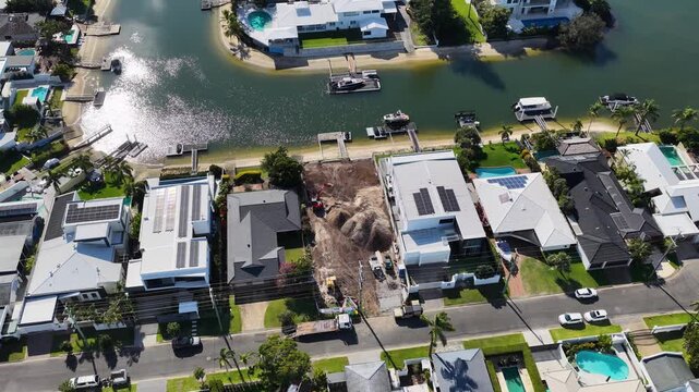 Aerial View of Waterfront Luxury Homes and Construction Site on Canal