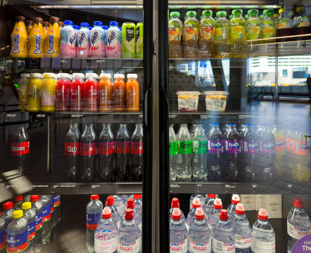 Refrigerated bottled drinks display inside convenience store in the Netherlands