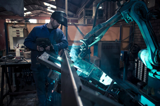 Welder welding metal with robot