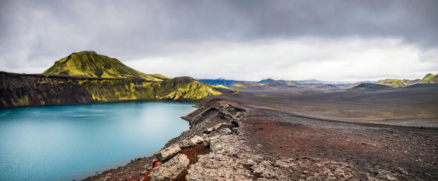 Vibrant turquoise water fills the ancient volcanic maar in Iceland