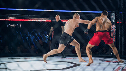 Obraz premium MMA Fighters Fight Trade Heavy Punches in a Live Cage Fight as the Referee Tracks the Action. Fast Striking and Real Contact Drive a Competitive Contest, With Loud Crowd Energy and Fight