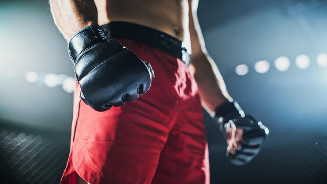 MMA Fighters Prepare to Fight Inside the Cage as a Athlete Sets a Firm Stance, Ready to Strike or Defend. Real Contact Sport, Strength, Championship Match, Fight for the Champion Title Belt