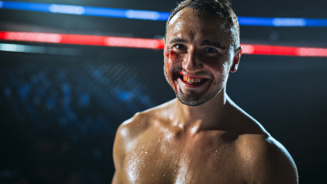 MMA Fighters End a Hard Fight in the Cage as a Bloodied Fighter Smiles After the Win. Fight for the Champion Title Belt, With Sweat, Cuts, and Grit.