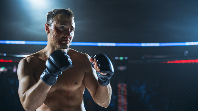 MMA Fighters Trade Strikes in a Hard Fight Inside the Cage. Fighter Holds a High Guard and Looks Forward, Showing Contact, Pressure, Focus During a Competitive Fight for the Champion Title Belt