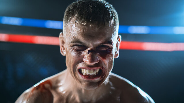 MMA Fighters Clash in a Fierce Cage Fight as a Bloodied Fighter Screams With a Cut Face, Hard Strikes, and Pain. Martial Arts Action in a Competitive Fight for the Champion Title Belt 