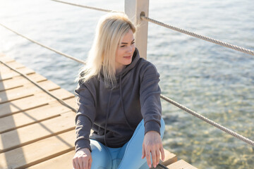 Naklejka premium A sexy woman on floating pontoon towards a posh resort. Lifestyle and recreation.