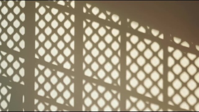 Sunlit lattice shadow pattern wall with warm sunlight creating geometric pattern and rhythmic