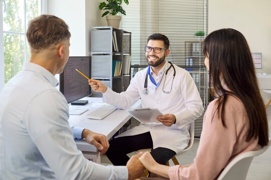Couple doctor clinic consultation fertility planning advice. The physician guides parents on pregnancy tests, timelines, and next steps in clinic. Trusted healthcare for growing families.