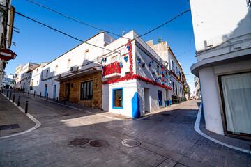 Fototapeta premium Beautiful white houses in narrow street, Conil de la Frontera, Spain, Costa de la Luz.