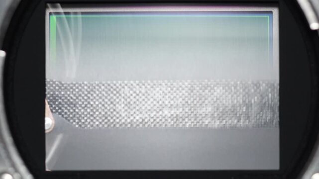 Extreme close-up of a mirrorless camera sensor with the mechanical shutter curtain triggering as it rapidly moves up and down, revealing the precision and speed of modern camera technology.