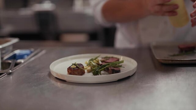 Chef plates a gourmet dish with precision and artistic flair