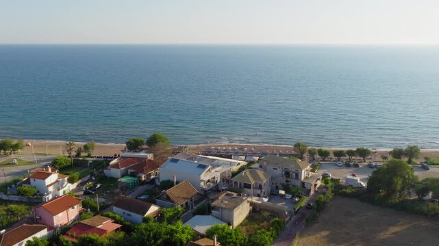 Seaside luxury hotels, restaurants reveal tree lined Kourouta beach and lush coastal vegetation, also known as Mykonos of mainland Greece, IIia, drone shot