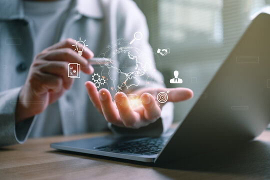 Digital transformation concept featuring a business professional using a virtual global interface above a laptop, innovation, AI technology, cloud computing, global business, enterprise connectivity.