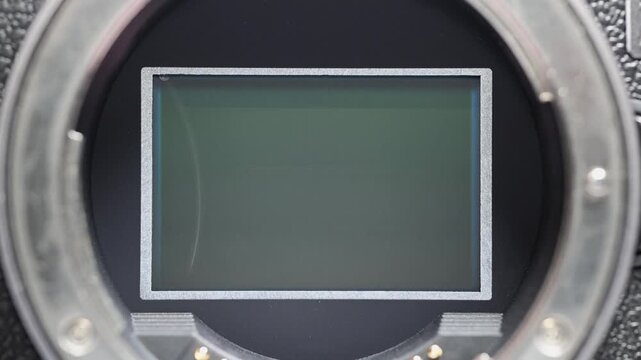 Extreme close-up of a mirrorless camera sensor with the mechanical shutter curtain triggering as it rapidly moves up and down, revealing the precision and speed of modern camera technology