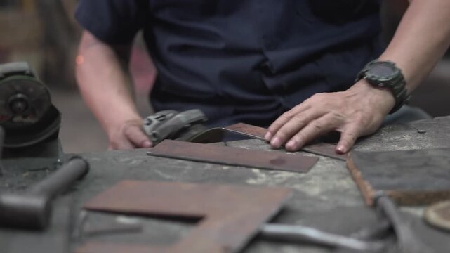 Skilled Machinist Using Angle Grinder in Small Local Machine Shop for Metalworking and Industrial Repair