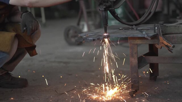 Experienced Machinist Cutting Steel with Industrial Metal Cutting Machine in Local Engineering Workshop	