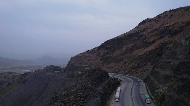 Vehicles travel along the Swat Kalam Motorway through rocky hills, Khyber Pakhtunkhwa, Pakistan