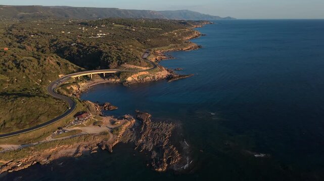 Coastal Road And Bridge Over Spiaggia del Cavalcavia In Alghero, Sassari, Italy. - aerial shot