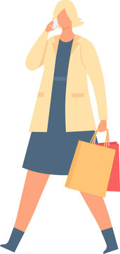 Woman walking, carrying shopping bags and speaking on a smartphone