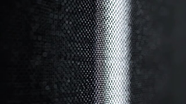 Dark metallic grid texture with bright light and blurred background