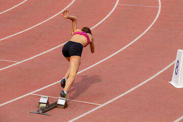 Obraz premium Start female athlete in 400-meter race during track and field event