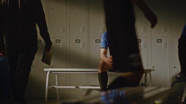 Realistic Portrayal of Youth Soccer Team After Game. One Teenage Boy Looks Devastated, Male Coach Sits Down to Provide Feedback and Motivation. Concept of Emotional Toll Competitive Youth Athletics.