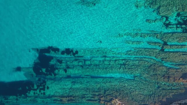 Clear Turquoise Water And Rocky Seabeds Of the Mediterranean Sea In Alghero, Sardinia, Italy. - aerial top-down shot
