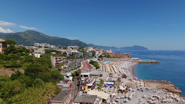 Drone shot of Corso Italia coastline in Genova with crowded beach and clear sea