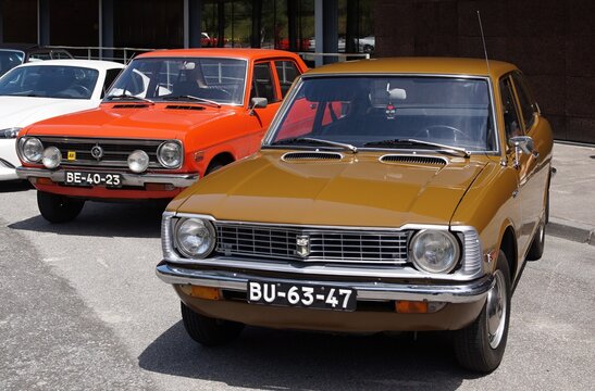 Vintage brown Toyota Corolla and orange Datsun 1200 classic cars
