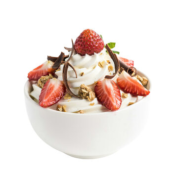 A white bowl filled with soft serve ice cream topped with fresh sliced strawberries, chocolate shavings, and granola on a white background