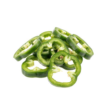 Fresh green jalape?o pepper slices arranged in a small pile, showing circular rings and seeds, isolated on a clean white background, studio shot