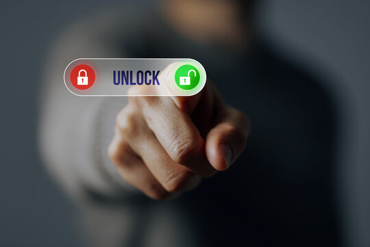 A hand pressing a button on a touchscreen to unlock information a concept of security technology.
