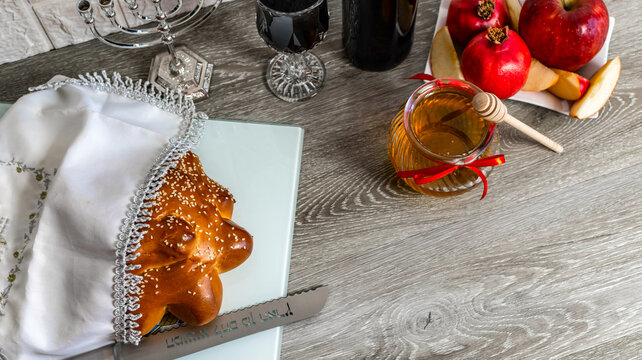 Rosh hashanah table setting with round challah and honey