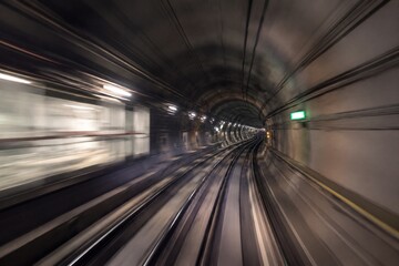 Fototapeta premium Perspective view of a subway tunnel with motion blur, capturing urban transportation atmosphere.
