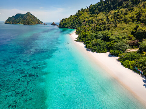 Aerial drone view of tropical landscape over Madam Beach of Nyaung Oo Phee Island in the Mergui Archipelago, Myanmar. Beautiful Andaman sea with white sand and turquoise water in Burma.