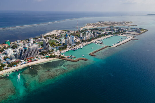 Aerial drone view of Maafushi, one of the inhabited islands of Kaafu Atoll in the Maldives. Maafushi island is popular for budget travel in Maldives.