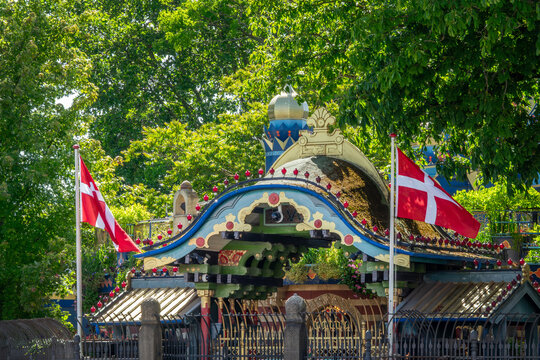 Entrance gate of the famous Tivoli gardens amusement park  with danish flages in Copenhagen, Denmark