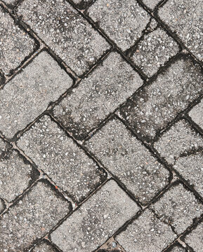 Natural concrete paving stones with rough surface texture and geometric pattern, showing urban construction material details for architecture, background design, and industrial concepts