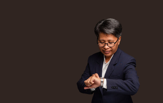 Short haired businesswoman checking wristwatch