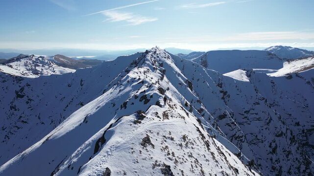 Drone View of Alpinist on Snow Covered Mountain Ridge During Winter Alpine Adventure