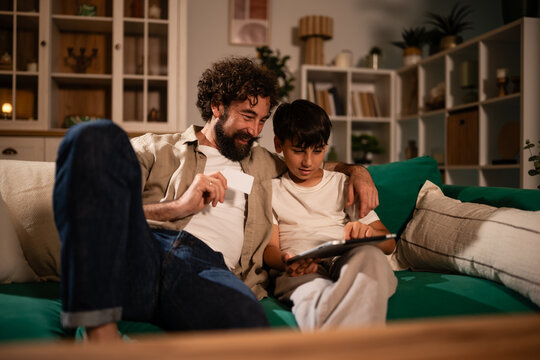 Father and son shopping online with digital tablet
