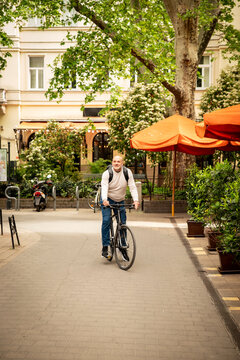 Active mature man riding a bicycle in the city