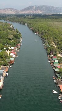 Scenic aerial footage of the bojana river in ulcinj, montenegro. The riverbanks are lined with traditional stilt houses and restaurants