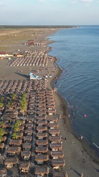 Aerial perspective of velika plaza in ulcinj, montenegro. People enjoying a sunny day, swimming in the adriatic sea and relaxing under umbrellas