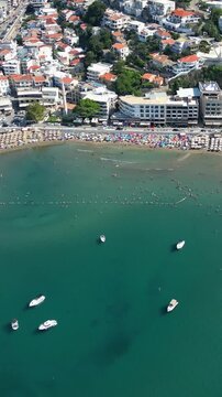 High angle view of ulcinj, montenegro, with its popular small beach, known as mala plaža, crowded with tourists enjoying the summer