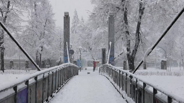 Heavy Snowfall in Sarajevo City with Snow Covered Bridge Over River, Winter Urban Landscape in Bosnia and Herzegovina