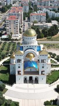 Aerial footage slowly approaching the cathedral of saint jovan vladimir. This orthodox church with golden domes is located in bar, montenegro