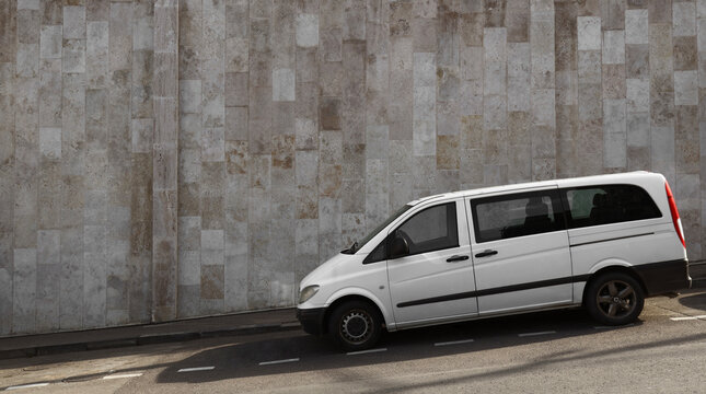 multivan riding on street. Commercial on city town background. White minibus mini bus  city road. 